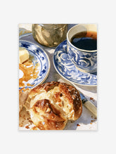 Watercolor illustration of coffee, bread, and blue patterned plates on a table, breakfast art print