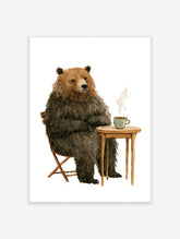Watercolor illustration of a brown bear sitting at a small wooden table with a steaming cup of coffee on white background