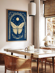Ornate cream butterfly within a decorative arch, with moon and stars on a deep blue background, in a styled room mockup