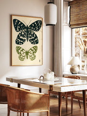 Botanical butterfly illustration art print with one black and one green butterfly on a light, in a styled room mockup