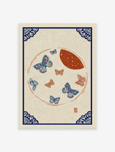 Traditional blue and red butterfly wall art print with a moon and ornate blue corner borders on a light background.