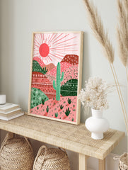 Illustrated cactus desert landscape wall art with pink and red mountains, green cactuses, and a bright sun. - Image 3