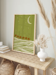 Illustrative camel caravan with six riders crossing sand dunes under a green night sky with, in an alternate framed mockup