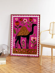 Stylized black camel with floral hump and pink flowers on a magenta background, designed as a perforated stamp print. - Image 2