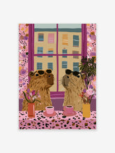 Two capybaras in sunglasses at a leopard-print table with pink coffee cups and flowers, pink window frame