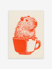 Orange ink illustration of a capybara sitting inside a teacup on off-white paper