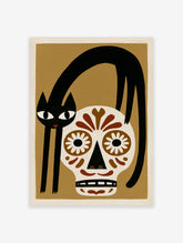 Illustrative wall art of a black cat arched over a brown and white sugar skull on a tan background