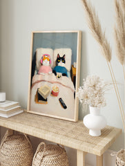 Oil painting of two cats in bed, one orange with pink headphones, one black and white with a remote, popcorn and books nearby. Cat Art. - Image 3