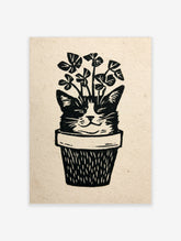 Linocut style illustration of a cat face emerging from a plant pot with clover leaves, black and white print