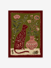 Folk art illustration of a red cat with floral patterns, sitting next to a vase with pink flowers on a green background.