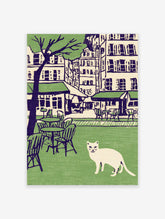 Illustration of a white cat in a green park with cafe tables, chairs, city buildings, and a tree in the background. Cat wall art.