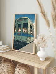 Illustrative art print of various cats looking out of the windows of a green Japanese train, in an alternate framed mockup