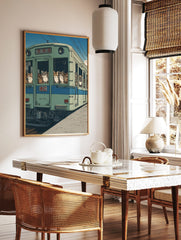 Illustrative art print of various cats looking out of the windows of a green Japanese train under a, in a styled room mockup