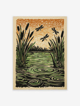Linocut print of a pond scene with black cattails, green water with ripples, three black dragonflies, and an orange sky