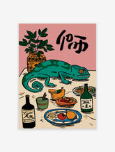 Illustrative wall art with a green chameleon on a table surrounded by a plant, bottles, fruit, and black calligraphy