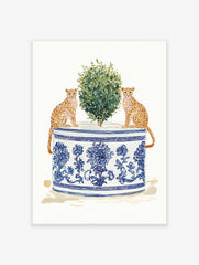 Watercolor art print of two cheetahs sitting by a green plant in a blue and white chinoiserie planter.