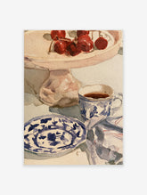 Watercolour still life art print featuring red cherries on a cake stand and a blue and white patterned teacup