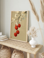 Japanese-style illustration of white cherry blossoms and red fruit on a tan background, in an alternate framed mockup