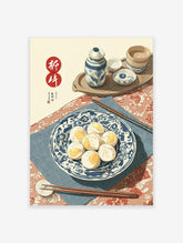 Traditional Chinese food art print of dim sum buns on a blue and white plate with chopsticks, tea set, and steamer.