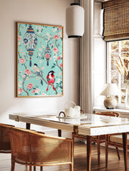 Chinoiserie art print with two colourful birds, pink blossoms, and blue lanterns on a teal, in a styled room mockup