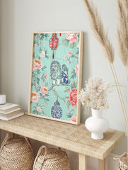 Chinoiserie foo dog on branch with pink peonies, green leaves, red and blue ornate lanterns, in an alternate framed mockup
