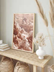 Aerial view of fluffy cumulus clouds in warm peach and white earth tones, filling the frame, in an alternate framed mockup