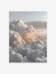 Aerial view of fluffy white and grey clouds with soft peachy light across a vast sky