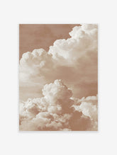 Warm sepia-toned photographic print of large, layered cumulus clouds against a soft sky