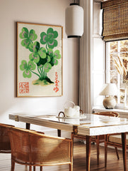 Clover botanical illustration with green leaves and pink accents, Japanese calligraphy, and red, in a styled room mockup