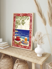 Illustrative coastal breakfast scene with coffee, croissant, orange juice, blue sea, green, in an alternate framed mockup