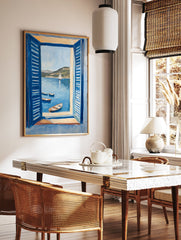 Coastal painting showing a sea view through blue open shutters, with boats in the water and hills in the background. - Image 2