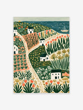 Colourful coastal village landscape art print with white cottages, orange tulips, and a blue sea