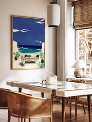 Illustrative coastal wall art of an outdoor terrace with seating overlooking a blue ocean and sky with clouds. - Image 2
