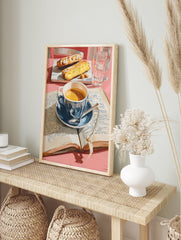 Coffee poster showing a blue cup of coffee, open book, and two pieces of cake on a pink table with water glasses. - Image 4