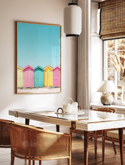 Colorful beach huts poster in yellow, pink, and teal on a sandy beach under a bright blue sky, coastal photography. - Image 2