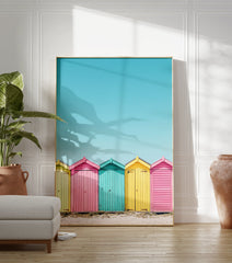 Colorful beach huts poster in yellow, pink, and teal on a sandy beach under a bright blue sky, coastal photography. - Image 3