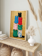 Colorful thread spools art painting stacked on a gold background, featuring blue, red, pink, green, and patterned white spools. - Image 3