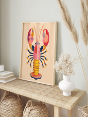 Colourful illustrative lobster wall art print with pink, orange, yellow, and navy blue dot, in an alternate framed mockup