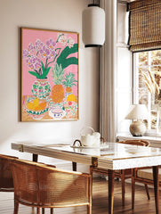 Colourful illustrative still life print with pink orchids, pineapples, mangoes, and patterned, in a styled room mockup