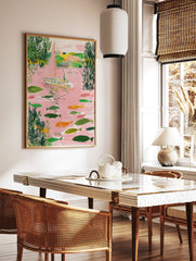 Illustrative sailboat with pink sail and many fish in a pink river with green foliage, in a styled room mockup