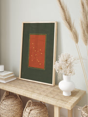 Vintage constellation art print featuring golden stars on a deep red background with black and gold borders, set on a green mat. - Image 3