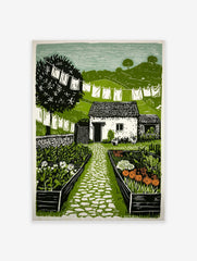 Linocut print of a cottage garden with a stone path, white cottage, flowers, clothesline, and green hills under a pale sky