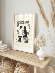 Monochrome illustration of a couple at a bar with bottles, glasses, and Japanese text on a, in an alternate framed mockup