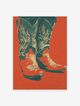 Pop art style poster featuring a pair of cowboy boots with decorative stitching against a vibrant red-orange background.