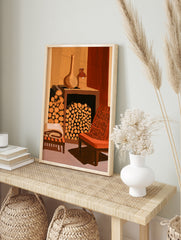 Illustrative wall art print of a fireplace filled with logs, ceramic pots, and an orange, in an alternate framed mockup
