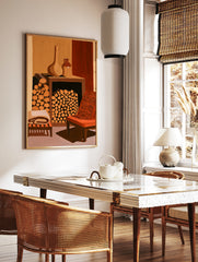 Illustrative wall art print of a fireplace filled with logs, ceramic pots, and an orange armchair, in a styled room mockup