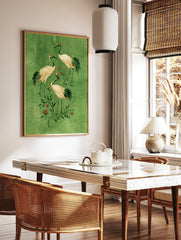 Japanese-inspired crane bird wall art illustration with orange fruit on a textured green background, in a styled room mockup