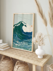 Illustrative art print of a large crashing ocean wave with blue, green, and white foam, in an alternate framed mockup