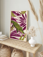 Green crocodile or alligator illustration with textured scales on a background of purple and, in an alternate framed mockup