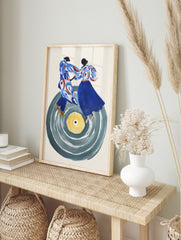 Abstract art print of two stylised figures dancing on a large grey vinyl record with a yellow, in an alternate framed mockup